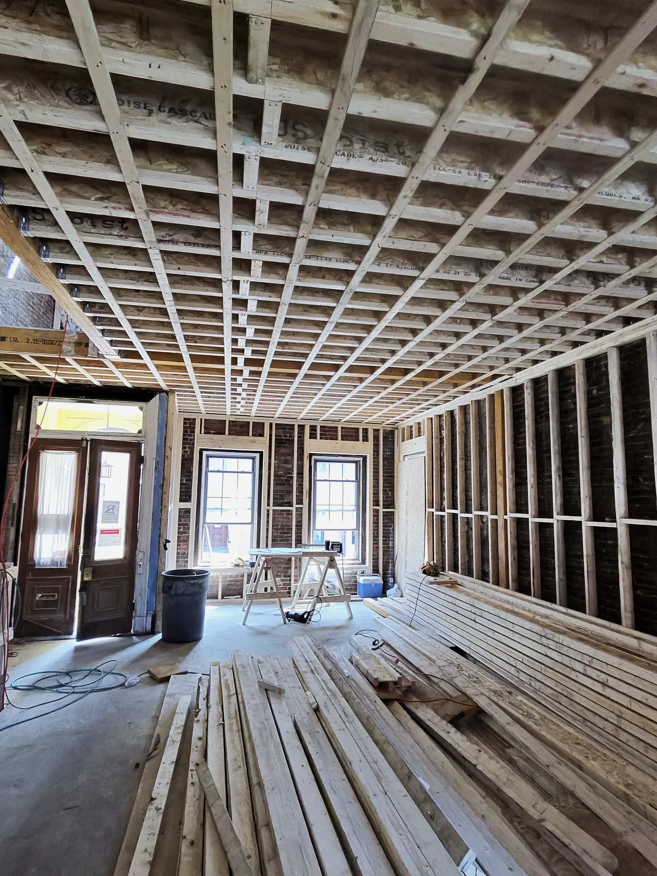 New floor framing and exposed brick in a Charlestown renovation