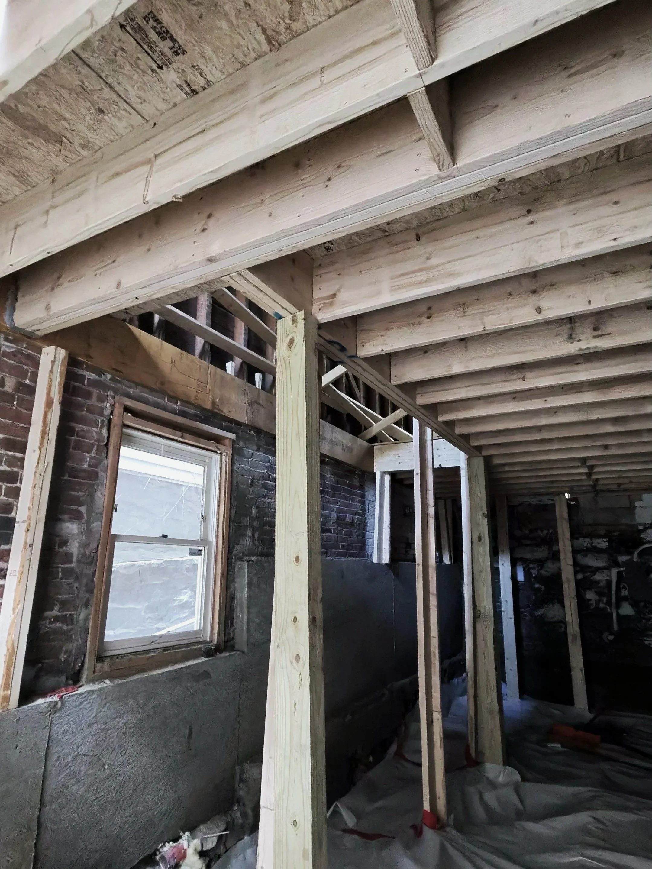New engineered floor framing, posts and beams over existing masonry