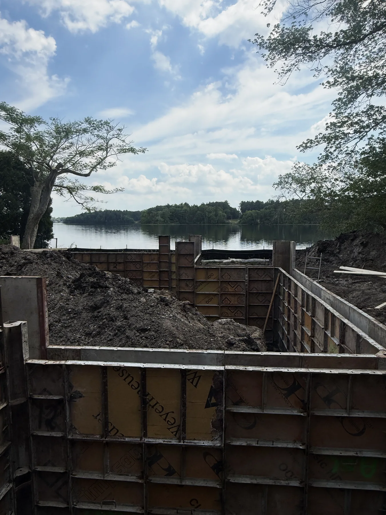 Concrete foundation forms beside a lake
