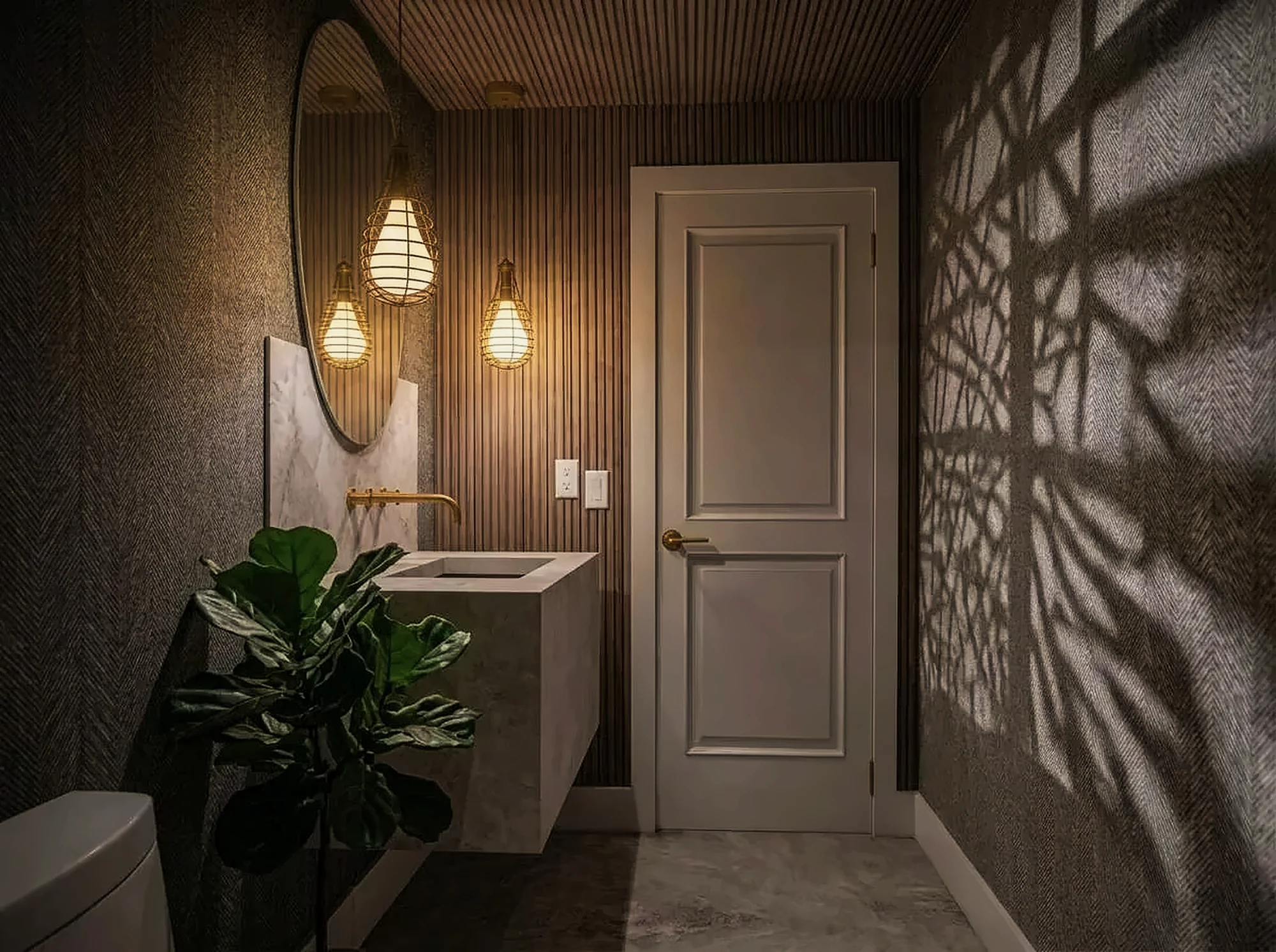 Powder room with fluted wood and stone vanity