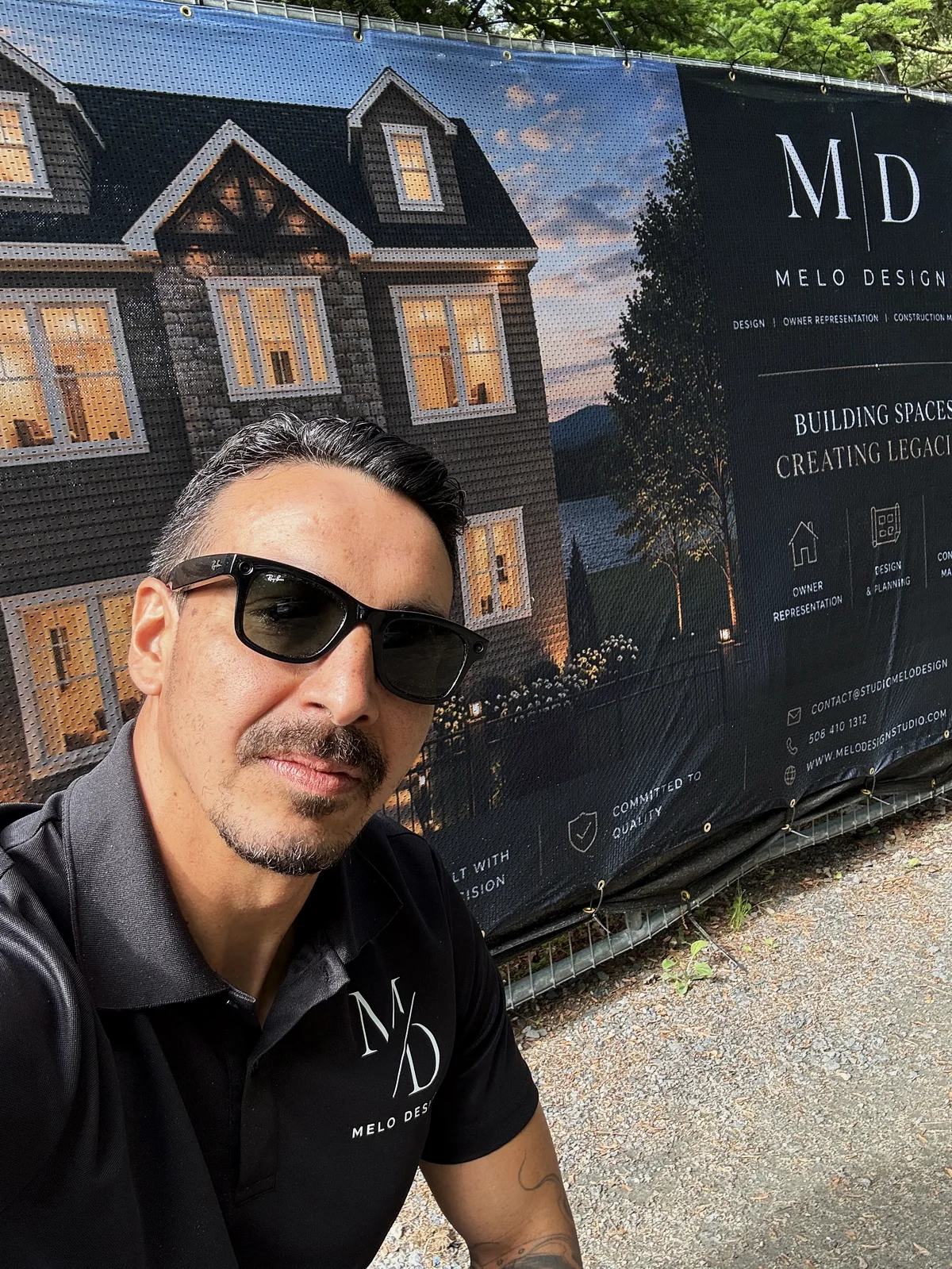 Moises Mendes on site in front of a Melo Design jobsite banner